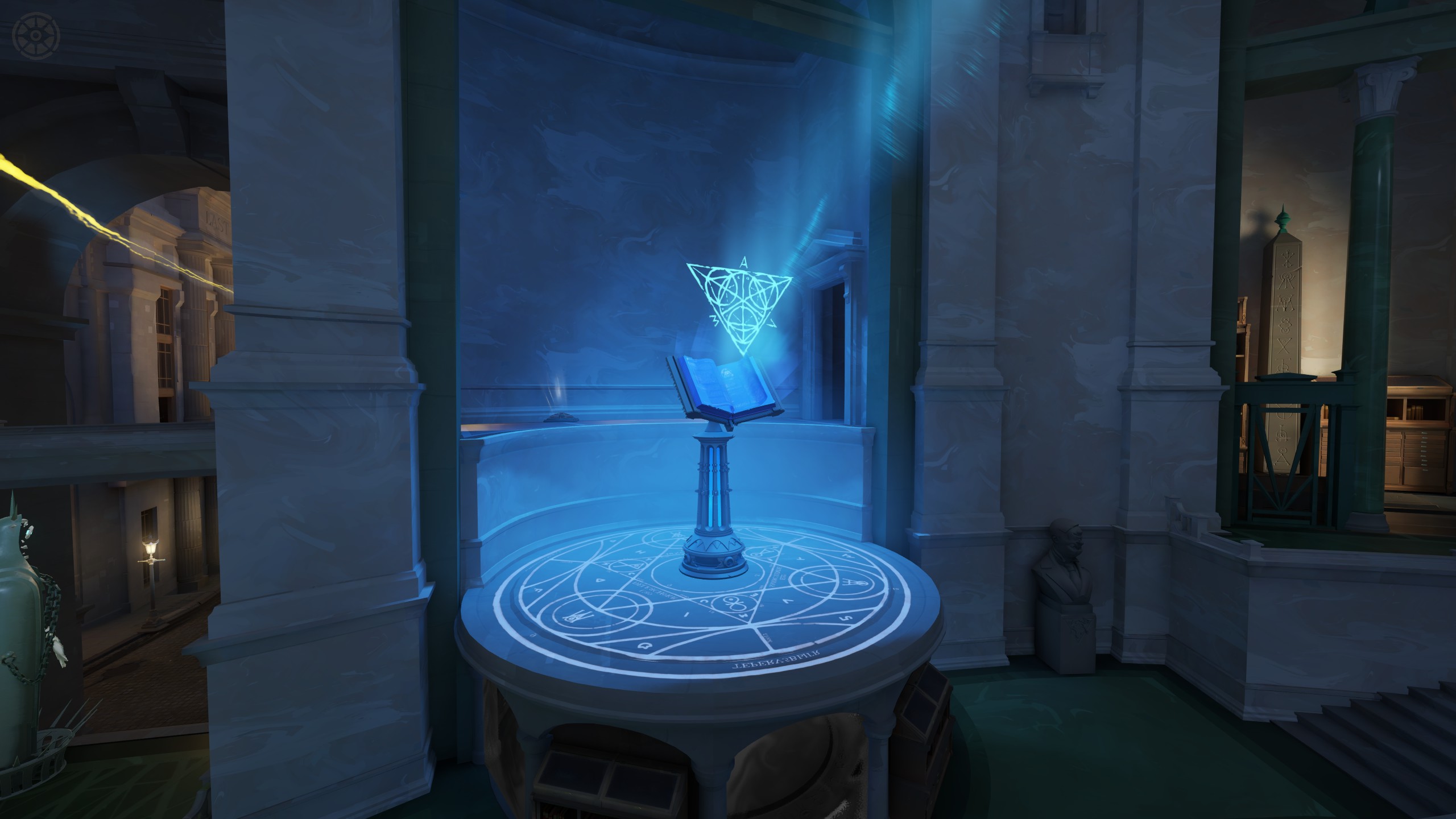 A glowing blue book above a pedestal in the Archmother base.