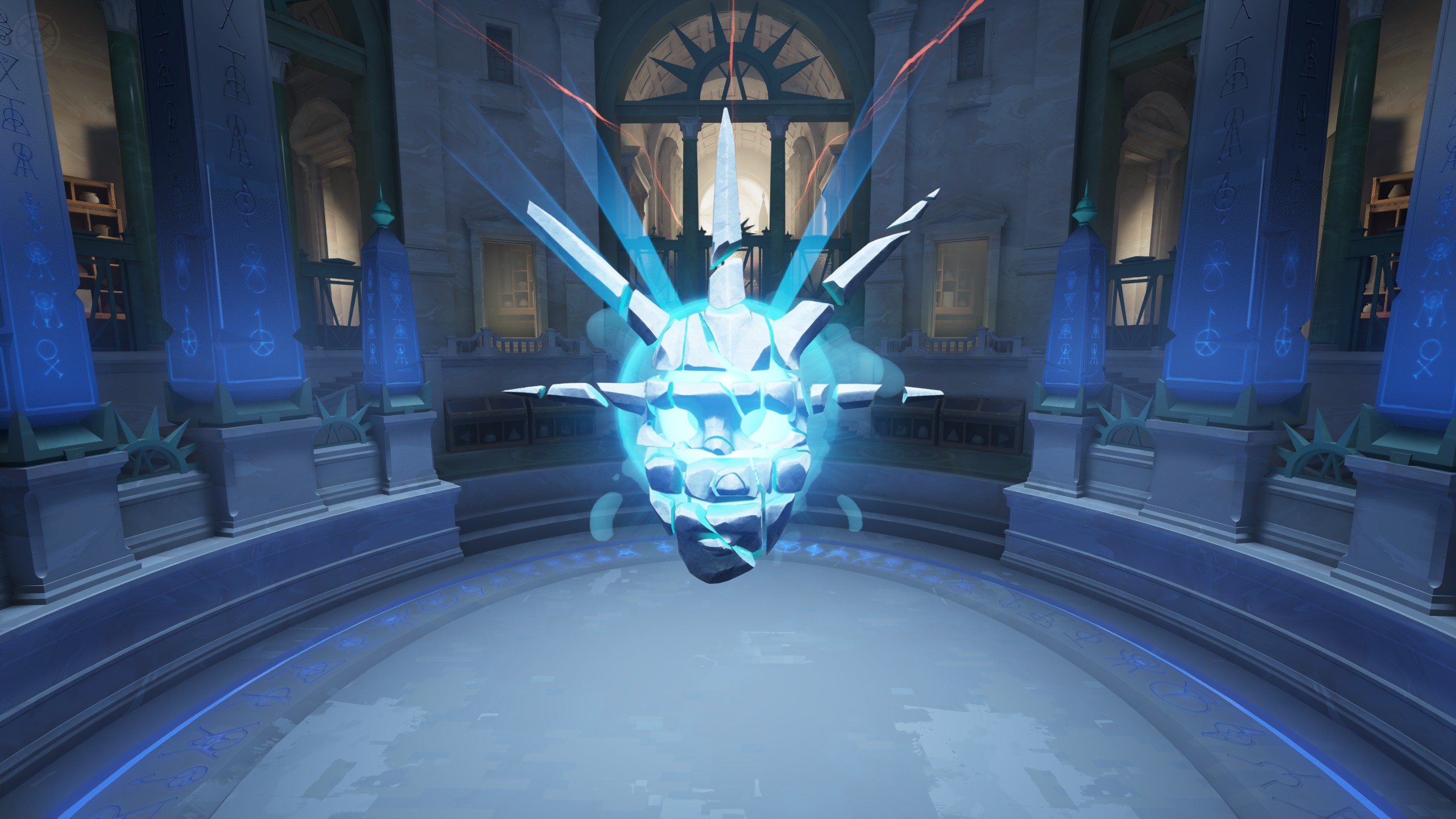 A fragmented pale face surrounding a cyan core in the Archmother base.